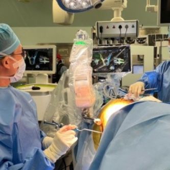 Guna Pratheep Kalanchiam and Jacob Yoong Leong Oh performing robotic assisted Lateral and Prone surgeries